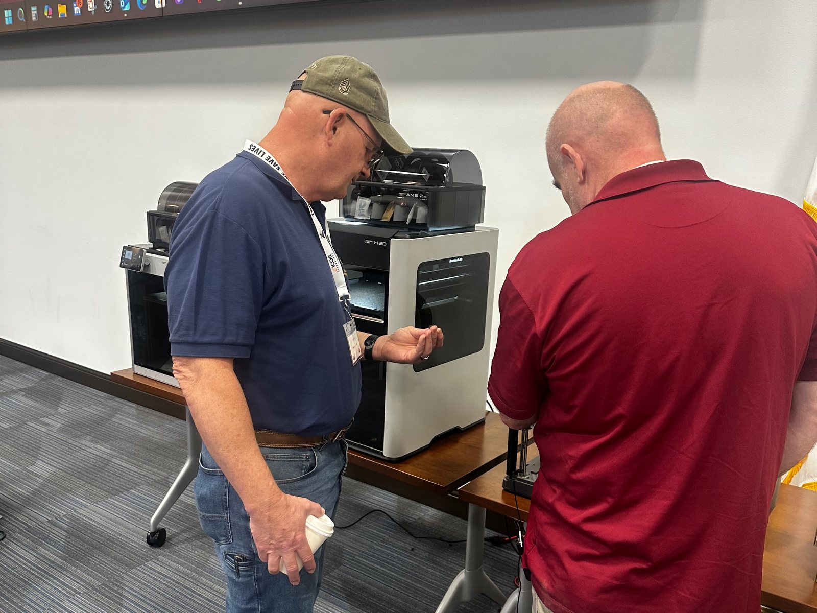 Bomb technicians working hands-on with a 3D printer